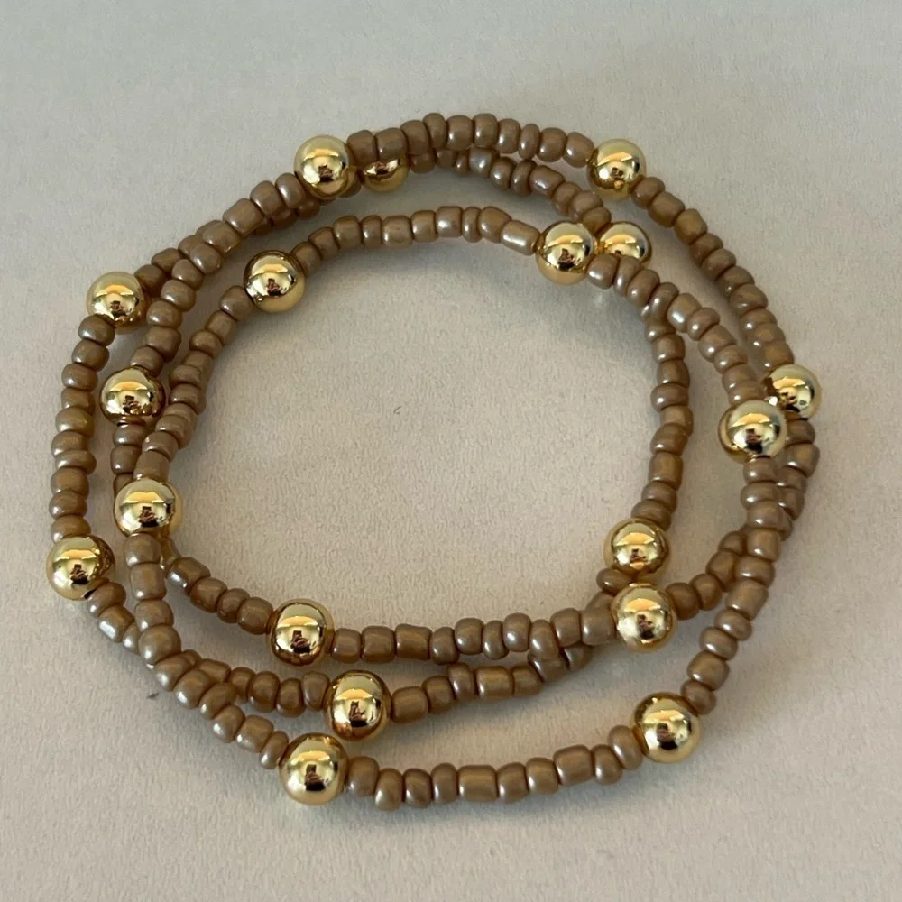 Brown/tan beaded bracelets with gold plated beads size 7”